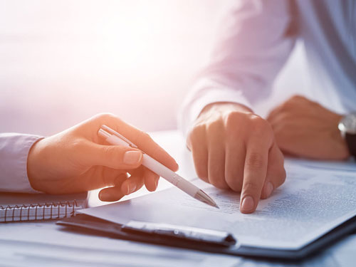 Two people reading through a document together